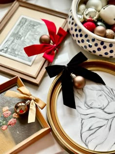 a table topped with framed pictures and ornaments