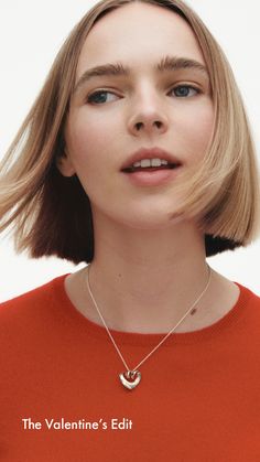 a woman wearing an orange sweater with the words the valentine's edit on it