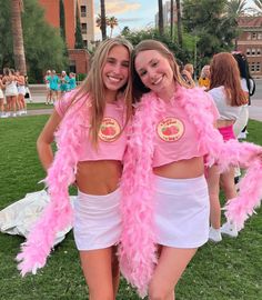 two girls in pink and white outfits posing for the camera with their arms around each other