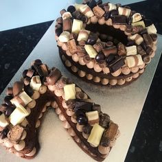 two cakes with chocolate and marshmallows are on a counter top next to each other