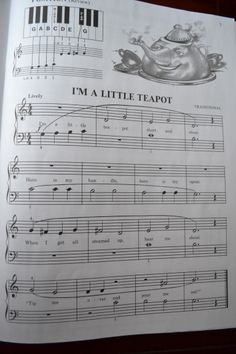 an open book with music sheets and musical notations on the front page, including i'm a little teapot