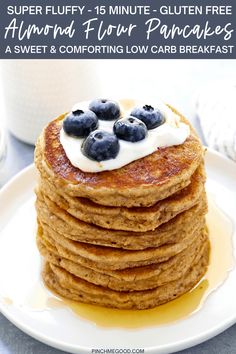 pancakes stacked on top of each other with blueberries and cream