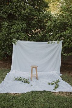 a white cloth draped over a stool in the grass