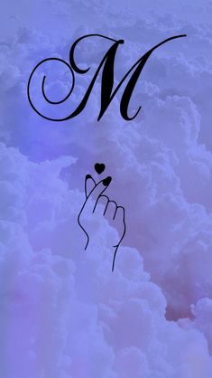 the letter m is written in cursive writing with a hand holding a heart