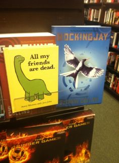 three books are on display in a bookstore, one is for children and the other is for adults