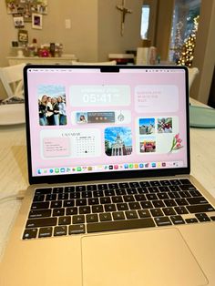 an open laptop computer sitting on top of a wooden table next to a white plate