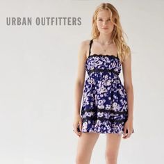 New Without Tag! New Urban Outfitters Eliana Strappy Back Floral Babydoll Dress Size: Large Color: Violet / Purple / Blue / Black / White Feminine And Dainty Babydoll Mini Dress From Urban Outfitters In A Floral Print. Cut With A Straight-Across Neckline, Empire Waist And A Swingy A-Line Mini Skirt Plus A Low-Cut Back With A Lace-Up Detail. Complete With Lace Trim Throughout. Content + Care - 96% Polyester, 4% Spandex - Machine Wash *New Without Tag! Still Has Tag Barb, Never Worn, Perfect Condi Purple Cotton Mini Dress For Day Out, Purple Cotton Mini Dress With Floral Print, Purple Summer Dress With Lace Trim, Summer Purple Dress With Lace Trim, Purple Lace Trim Summer Dress, Purple Mini Dress With Lace Trim, Purple Cotton Mini Dress For Vacation, Purple Cotton Mini Dress With Ruffles, Urban Outfitters Ruffled Mini Dress For Beach