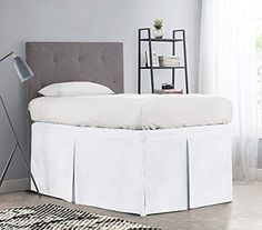 a white bed with a gray headboard and foot board