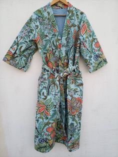 This Kimono is made of hand Kantha stitch fabric in patchwork . The fabric is a handmade printed fabric. Kantha stitch over the fabric gives it a unique look. It is two Layer of Cotton Kantha Stitch (Hand Quilted) Fabric Robe Size : Free size Length: 50 Inch ( 125 Cms.). Note: Due to patchwork theme there may be little difference in patches and color combination. Summer Cotton Kimono With Pockets, Green Summer Sleepwear With Pockets, Cotton Sleepwear With Pockets For Vacation, Fitted Green Cotton Sleepwear, Fitted Multicolor Cotton Sleepwear, Multicolor Cotton Kimono For Home, Green Printed Cotton Kimono, Fitted Multicolor Cotton Kimono, Beachwear Cotton Kimono With Print