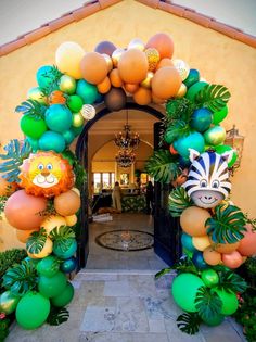 an entrance decorated with balloons and jungle animals