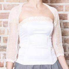 This loose knit white linen bolero is made of 100% linen yarn. Elegant way to keep your shoulders warm on chilly days and evenings on that special wedding day. This bolero also looks good with any type of gown for special occasions and date nights. It is possible to order a custom clothing in your size and color. Made from high quality Italian yarn. Hand wash only, dry flat. This is SuperSoftKnits original. More boleros: https://www.etsy.com/shop/supersoftknits?ref=hdr_shop_menu&section_id=1 Elegant White Fitted Cardigan, Chic Fitted Lace Cardigan, White Chic Fitted Shrug, Elegant Cream Cardigan For Wedding, White Party Shrug For Spring, Elegant Fitted Cardigan For Weddings, White Cardigan For Spring Wedding, Fitted Summer Wedding Shrug, Fitted Shrug For Summer Wedding