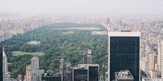 an aerial view of new york city with the central park in the foreground and surrounding skyscrapers