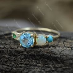 This ring is made with Genuine Sleeping Beauty Arizona Turquoise/ Zambia Emerald/ Blue Topaz & Ethiopian Opal Gemstone & SI Clarity G-H Color Diamond and 14K solid yellow gold * SKU: SGR01148 * Made to Order * Gold Purity: 14K Solid Yellow Gold (stamped) * Custom Gold Color: Rose Gold, Yellow Gold, White Gold * Custom Gold Purity: 9K/14K/18K (Charges Apply) * Diamond 100% Genuine Diamond * Diamond weight: 0.03 ct * Diamond Color: G-H * Diamond Clarity: SI1- SI2 * Diamond Cut: Brilliant C Turquoise Multi-stone Gemstones, Turquoise Multi-stone Round Gemstones, Turquoise Multi-stone Round Opal Ring, Blue Emerald Ring For May Birthstone, Blue Emerald Ring For May Birthstone, Round Shape, Blue Wedding Birthstone Gemstones, Blue Birthstone Gemstones For Wedding, Aquamarine Three Stone Wedding Rings, Aquamarine Three-stone Wedding Rings