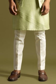 Pista green open nehru jacket with multicolour threadwork embroidery. Paired with a silk kurta with pintuck detailing on the front and cream pyjama. - Aza Fashions Spring Green Bandhgala With Resham Embroidery, Fitted Green Sherwani For Spring, Green Bandhgala With Zari Work For Spring, Spring Green Embroidered Sherwani, Green Sherwani For Festive Spring Occasion, Spring Embroidered Green Sherwani, Spring Green Nehru Jacket With Zari Work, Green Long Sleeve Sherwani For Spring, Ceremonial Green Nehru Jacket With Chikankari Embroidery