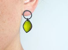 Leaf earrings in oxidized silver and lime green enamel. Measurements: 35mm long and 15mm width. Closure: push back. These contemporary earrings are handcrafted and unique piece. These enamel earrings belong to the Pètals collection. Very light and comfortable to wear. They will be perfect for everyday. The design of these earrings is inspired by the color and beauty of a flower. Choose the enamel color that you like the most. I can also make them in white matt silver. Customize them as you like Green Enamel Single Earring, Single Green Enamel Earring, Green Oxidized Drop Earrings, Green Oxidized Finish Earrings For Gift, Green Sterling Silver Earrings With Oxidized Finish, Modern Silver Earrings, Oxidized Silver Earrings, Earrings Leaf, Contemporary Earrings