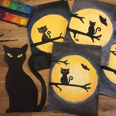 three black cats sitting on top of a tree branch in front of a full moon