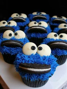 cupcakes with blue frosting and black icing decorated to look like cookie monster eyes