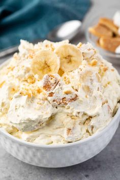 a white bowl filled with banana cream and topped with sliced bananas