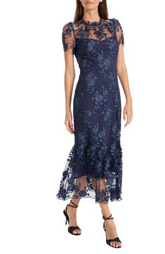 Tonal blooms float over the airy mesh layered onto a charming cocktail dress that will turn heads. 50" length (size 8) Hidden back-zip closure Jewel neck Short sleeves Lined 100% nylon Dry clean Imported Lace Tea Length Dress, Ruffle Midi Skirt, Navy Gown, Mother Of The Bride Gown, Floral Overlay, What To Wear To A Wedding, Scallop Hem, Lace Overlay Dress, Illusion Dress