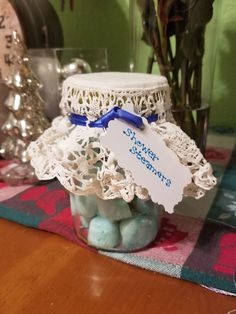 a jar filled with blue and white rocks