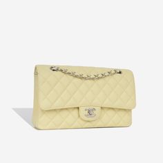 For timeless Parisian-chic there is no better investment than a Chanel classic flap bag. Created in a beautiful pale yellow caviar leather, in the coveted Medium size. This Chanel comes with all the iconic features including multiple compartments and pockets. The interwoven chain sits elegantly on your shoulder or doubled up on your arm.   SPL Exterior  Pale yellow caviar leather Silver tone hardware  CC twistlock closure Slip pocket at rear of bag 2018 production   Excellent condition - some light corner wear and hairline scratches to CC  Interior   Yellow leather interior  Double flap Zip compartment on first flap Two slip pockets at interior wall Excellent condition - one small mark under second flap  Sold with box and dustbag only   SPL  Height 16cm Width 26cm   Depth 7cm High End Handbags, Bags 2014, Neutral Bag, Chanel Classic Flap Bag, Classic Flap Bag, Stylish Shoulder Bag, Chanel Caviar, Black Caviar, Leather Silver