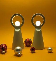 three different types of christmas ornaments in front of a yellow background with one red ornament and the other silver