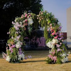 an arch made out of flowers and greenery