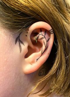 a person with a tattoo on their left ear