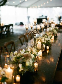 a long table with candles and flowers is shown on the instagram page for wedding decor