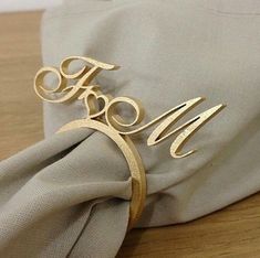 a gold monogrammed ring sits on top of a napkin