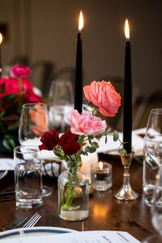 the table is set with flowers and candles