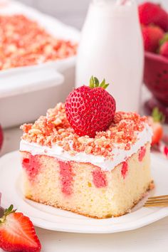 a close up of a cake on a plate with strawberries