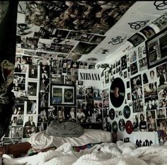 a bedroom with many pictures on the wall