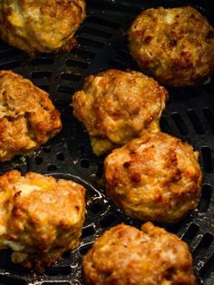 some meatballs are cooking on a grill