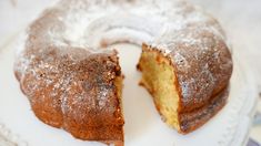 a bundt cake on a plate with one slice cut out