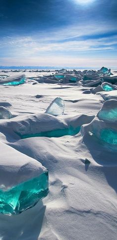 an icy landscape with ice chunks and blue water