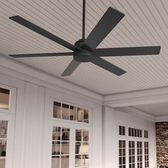 a ceiling fan mounted to the side of a wall in a room with white walls