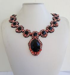 Each piece of our statement necklaces is handmade and one of a kind made in Italy. Our creations is made of high quality materials such as crystals and rhinestones. Each embroidered material is carefully hand sewn. Very glamorous and stylish. Perfect gift to someone you like. Materials Strass stones in Rose peach and Jet color in different shape and dimension.  Black eco leather backing. Aluminium color hook closure. Measurements Weight approximate 150 grams. Circumference approximate 59 cm - 23,22 in Feel free to contact us if you have any question. Thank you so much for looking at our shop and our articles each of them, single piece. Embroidered Material, Rose Peach, Jewel Necklace, Statement Necklaces, Gifts For My Sister, Choker Necklaces, Gorgeous Necklaces, How To Make Beads, Hand Sewn