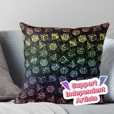 a colorful pillow with the words support independent artists on it and an image of symbols