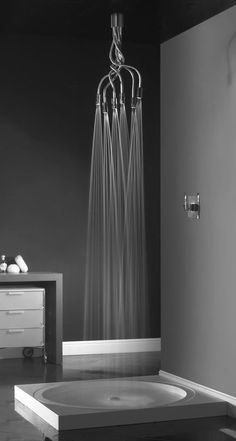 a bathroom with black walls and white fixtures in the bathtub, chandelier and shower head