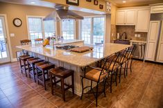 a large kitchen with an island in the middle