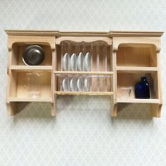 a wooden shelf with dishes and glasses on it