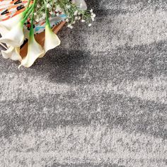 a bouquet of flowers sitting on top of a gray and white carpeted flooring