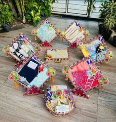 several pieces of colorful furniture sitting on top of a wooden floor next to potted plants