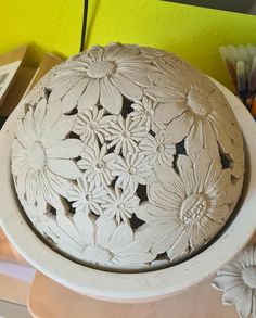 a white vase sitting on top of a table