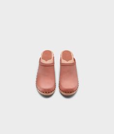 Made by skilled artisans in Sweden, these blush pink nubuck clog mules feature a high heel and eye-catching stud detailing on the sides. From date nights to ladies' nights out, Rome delivers unparalleled style and confidence. Clog measurements:Heel height: 2 5/8” (6.5 cm)Toe height:﻿ 1 1/2″ (3.8 cm) Fit:NarrowLeather:Nubuck leatherClogs consist of:Base: European Lime Wood Sole: Rubber sole Fastening: Brass studs Spring Slip-on Clogs With Studded Rubber Outsoles, Spring High Heel Clogs With Studded Rubber Outsoles, Pink Leather Mules With Block Heel, Leather Open Toe Clogs With Contrasting Heel, Spring Slip-on Mules With Studded Rubber Outsoles, Spring Slip-on Mules With Studded Outsoles, Pink Closed Toe Heels With Rubber Sole, Casual Pink Leather Mules, Pink Rubber Sole Clogs For Spring