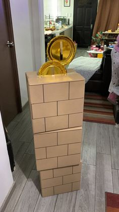 there is a cardboard box made to look like a gold plate on top of it