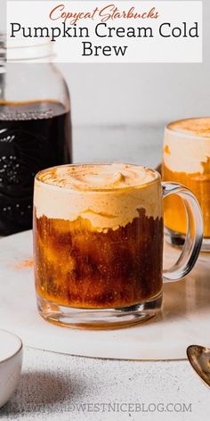 two mugs filled with pumpkin cream cold brew next to each other on a table