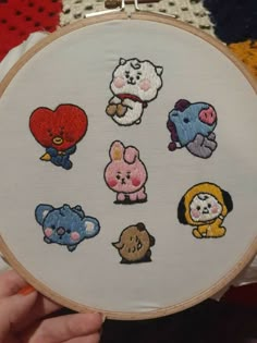 someone is holding up a cross - stitch embroidery kit with many different animals on it