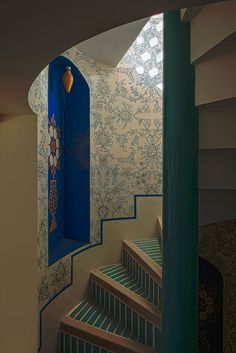 the stairs are decorated with blue and white wallpaper, along with an intricate design